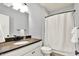 Bathroom with modern vanity, stylish lighting and a shower curtain that provides privacy at 14458 Smickle Ln, Carmel, IN 46033