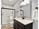 Stylish bathroom with a sleek vanity, marble countertop, and a glass-enclosed shower featuring white tile at 14458 Smickle Ln, Carmel, IN 46033