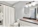 Bathroom with white vanity, quartz countertop, decorative mirror and shower with a curtain at 14458 Smickle Ln, Carmel, IN 46033