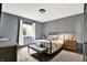 Cozy bedroom with a black metal bed frame, neutral bedding, and natural light from the window at 14458 Smickle Ln, Carmel, IN 46033