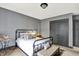 Bedroom featuring neutral gray walls, black metal bed frame, and a view of the closet at 14458 Smickle Ln, Carmel, IN 46033