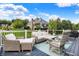 Cozy outdoor deck with wicker furniture, an area rug, and a view of the home's exterior at 14458 Smickle Ln, Carmel, IN 46033