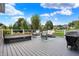 Spacious outdoor deck area with seating and a hot tub overlooking the lush yard at 14458 Smickle Ln, Carmel, IN 46033