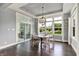 Dining room features dark wood floors, large windows, and a sliding glass door to outdoor patio at 14458 Smickle Ln, Carmel, IN 46033