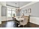 Spacious dining room with dark hardwood floors, pendant lighting, and wainscoting for an elegant atmosphere at 14458 Smickle Ln, Carmel, IN 46033