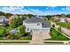 Aerial view of a gray home with a three car garage, deck, and mature trees at 14458 Smickle Ln, Carmel, IN 46033