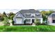 Beautiful two-story home with a well-manicured lawn and professionally landscaped yard at 14458 Smickle Ln, Carmel, IN 46033