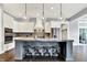 Kitchen with white cabinets, an island with seating, stainless appliances, and pendant lights at 14458 Smickle Ln, Carmel, IN 46033