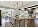Open concept kitchen with a large island, stainless appliances, and view of the living room at 14458 Smickle Ln, Carmel, IN 46033