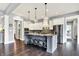 Kitchen with stainless appliances, a large island with seating, and white cabinets at 14458 Smickle Ln, Carmel, IN 46033