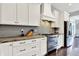 Modern kitchen with stainless steel appliances, white cabinets, and marble countertops at 14458 Smickle Ln, Carmel, IN 46033