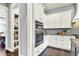 Well-lit kitchen featuring stainless steel appliances, white cabinets, and a pantry at 14458 Smickle Ln, Carmel, IN 46033