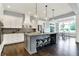 Bright kitchen featuring white cabinets, a kitchen island with seating, and stainless appliances at 14458 Smickle Ln, Carmel, IN 46033