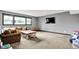 Basement living room features a couch, coffee table, large window, and TV, offering a perfect space for relaxation at 14458 Smickle Ln, Carmel, IN 46033
