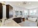A main bathroom offers double sinks, a vanity area, a soaking tub, and modern lighting fixtures at 14458 Smickle Ln, Carmel, IN 46033