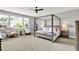 This expansive main bedroom features a four poster bed, ceiling fan, and sitting area with natural light at 14458 Smickle Ln, Carmel, IN 46033