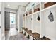 Mudroom featuring built-in shelving and bench with convenient storage cubbies and tile flooring at 14458 Smickle Ln, Carmel, IN 46033