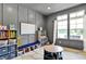 Bright playroom features gray wainscoting, natural light, and organized shelving for homeschooling and fun activities at 14458 Smickle Ln, Carmel, IN 46033