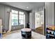 Bright playroom features gray wainscoting, natural light, and an open doorway to the home's foyer at 14458 Smickle Ln, Carmel, IN 46033