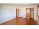 Bright bedroom featuring polished hardwood floors, closet, window and neutral paint at 1460 W Mckay Rd, Shelbyville, IN 46176