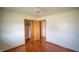 Bedroom showcasing hardwood floors and an open closet at 1460 W Mckay Rd, Shelbyville, IN 46176