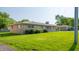 Well-maintained single-story house featuring stone, a mature lawn and an attached carport at 1460 W Mckay Rd, Shelbyville, IN 46176