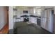 Modern kitchen featuring white cabinets, stainless steel appliances, and a sleek black countertop at 1460 W Mckay Rd, Shelbyville, IN 46176