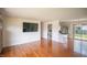Bright living room featuring gleaming hardwood floors, neutral walls and a large window at 1460 W Mckay Rd, Shelbyville, IN 46176