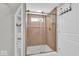 Modern walk-in shower featuring glass doors, tile surround, and a built-in niche at 14918 E 206Th St, Noblesville, IN 46060