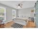 Light-filled bedroom with hardwood floors, fan, and stylish barn door to bathroom at 14918 E 206Th St, Noblesville, IN 46060