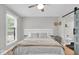 Serene bedroom showcasing ample natural light, ceiling fan, and charming barn door at 14918 E 206Th St, Noblesville, IN 46060