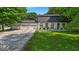 Charming painted brick home featuring a three-car garage and well-manicured lawn at 14918 E 206Th St, Noblesville, IN 46060