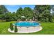 Above-ground pool with surrounding deck, set in a lush, green backyard at 14918 E 206Th St, Noblesville, IN 46060