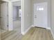 Bright foyer with hardwood flooring, neutral paint, and a white front door creates a welcoming entrance at 16774 Imperial Ct, Fishers, IN 46040