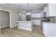 Modern kitchen with stainless steel appliances, white cabinets, and a center island for meal preparation at 16774 Imperial Ct, Fishers, IN 46040