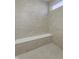 Walk-in shower with neutral tile and a built in bench at 16774 Imperial Ct, Fishers, IN 46040