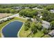Aerial view featuring a house next to pond, with mature trees, and green lawn at 17635 Willow Creek Way, Westfield, IN 46074
