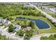 Aerial view of the property showcasing a pond, lush greenery, and neighborhood surroundings at 17635 Willow Creek Way, Westfield, IN 46074