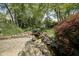 Landscaped backyard featuring a beautiful rock waterfall, small pond, and patio at 17635 Willow Creek Way, Westfield, IN 46074