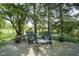 Outdoor living space includes a stone patio with comfortable seating and mature trees at 17635 Willow Creek Way, Westfield, IN 46074