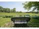 Relaxing bench with a view of the pond and manicured backyard at 17635 Willow Creek Way, Westfield, IN 46074