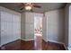 Bedroom with hardwood floors, a ceiling fan, and an open doorway at 17635 Willow Creek Way, Westfield, IN 46074