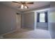 Carpeted bedroom with natural light, featuring a ceiling fan and simple decor at 17635 Willow Creek Way, Westfield, IN 46074