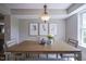 Dining room with a modern light fixture and an artistic heron-themed triptych on the wall at 17635 Willow Creek Way, Westfield, IN 46074