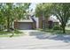 Brick home featuring a two-car garage, well-maintained lawn, and mature trees along a residential street at 17635 Willow Creek Way, Westfield, IN 46074