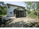 Exterior view of the home featuring a screened-in porch, patio, and landscaped backyard at 17635 Willow Creek Way, Westfield, IN 46074