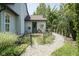 Back exterior of home with a small gravel walkway and landscaped garden at 17635 Willow Creek Way, Westfield, IN 46074