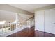 Upstairs hallway with hardwood floors, a view to downstairs, and a double closet at 17635 Willow Creek Way, Westfield, IN 46074