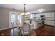 Bright kitchen features white cabinets, stainless appliances, island with breakfast bar, and a dining area at 17635 Willow Creek Way, Westfield, IN 46074