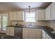 Bright kitchen features white cabinets, stainless appliances, and double doors leading to outdoor deck at 17635 Willow Creek Way, Westfield, IN 46074
